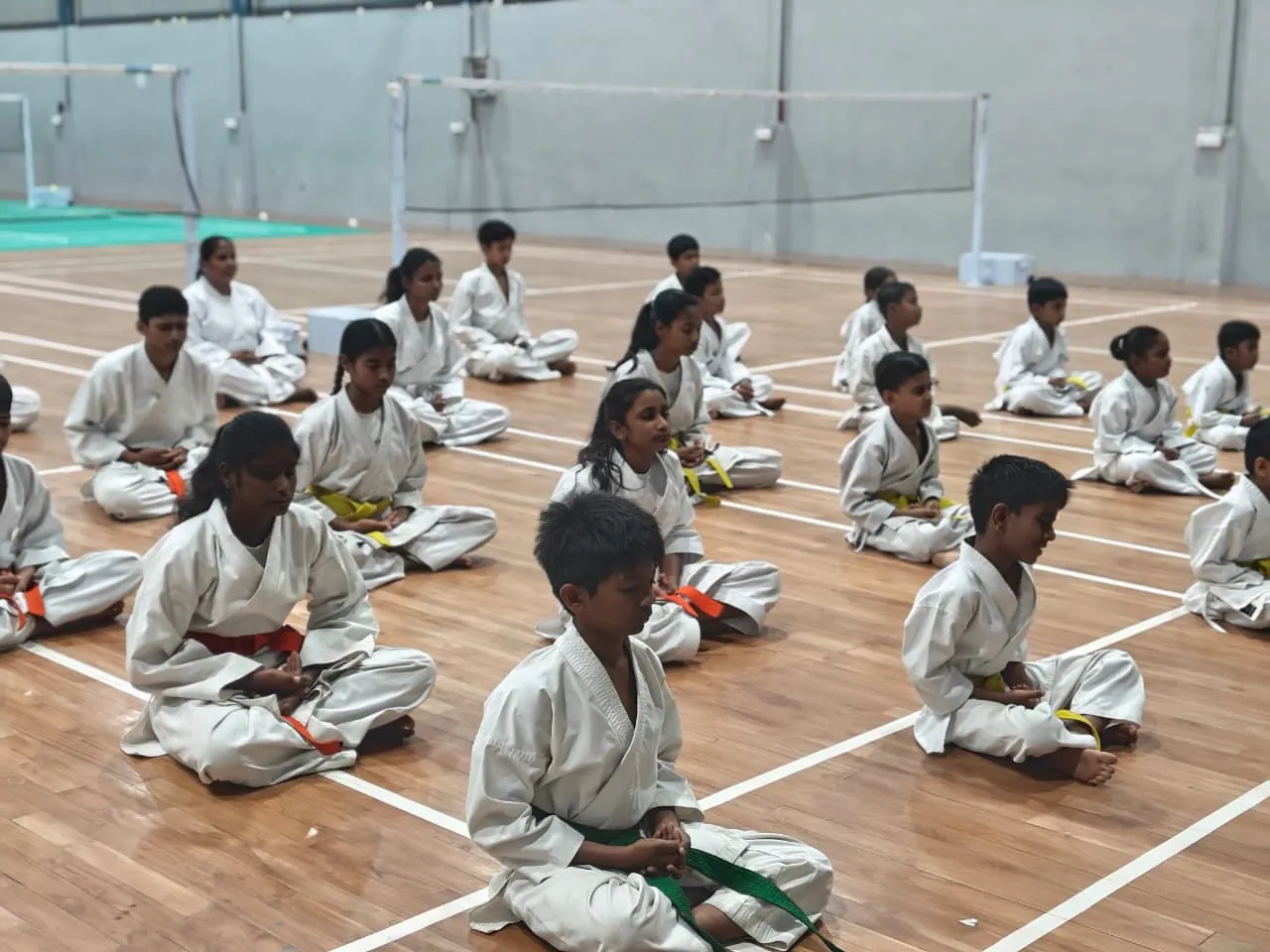 Students practicing karate in a hall
